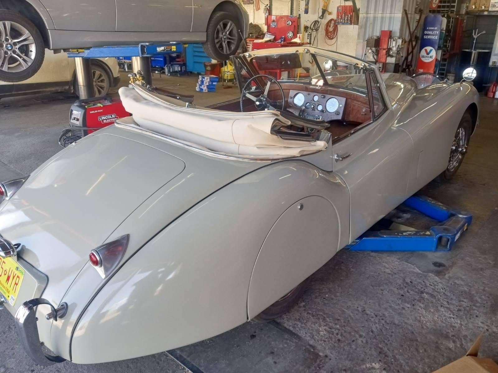 Classic Jaguar on the lift at Cagle Tire & Auto shop